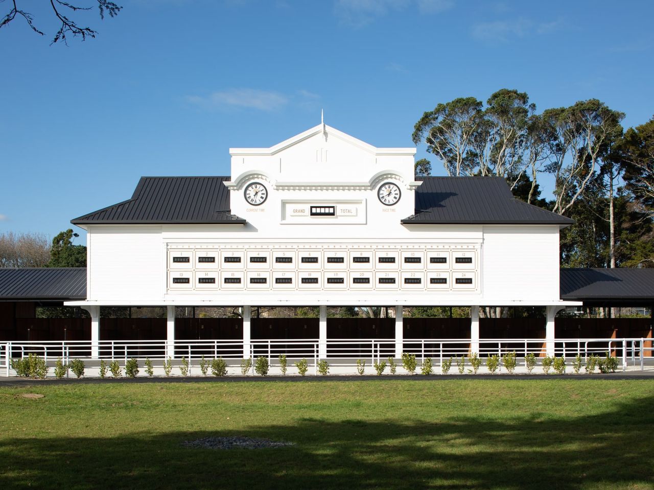 Heritage-style stables building at Auckland Racing Club, Ellerslie, featuring white facade, clock detail, and numbered stalls