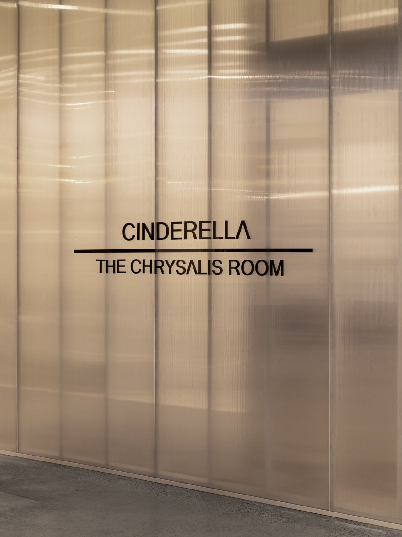Close-up of The Chrysalis Room signage at Cinderella Beauty, Westfield Newmarket, on a sleek, modern wall.
