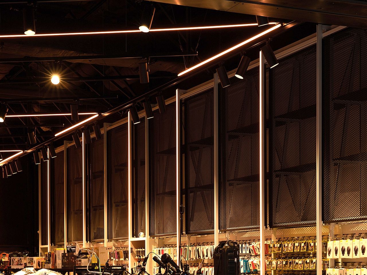 Close-up of Mobie retail fit-out in Westfield Newmarket, highlighting vertical LED lighting and perforated wall panels.