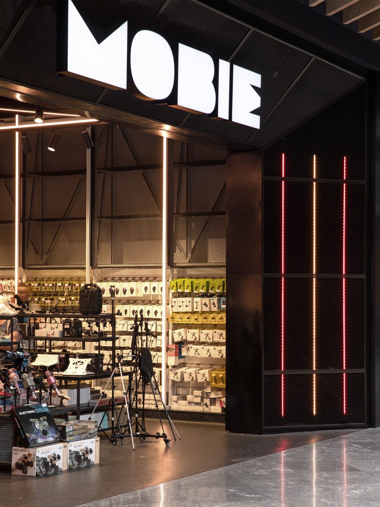 Entrance to Mobie retail fit-out in Westfield Newmarket, featuring illuminated signage, product displays, and modern lighting accents.