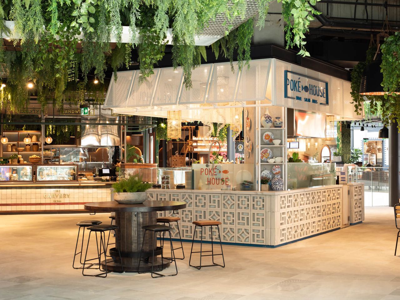 Poke House restaurant in Westfield Mall, featuring vibrant greenery, patterned counters, decorative accents, and inviting seating areas. A contemporary example of retail and hospitality interior design in Auckland.