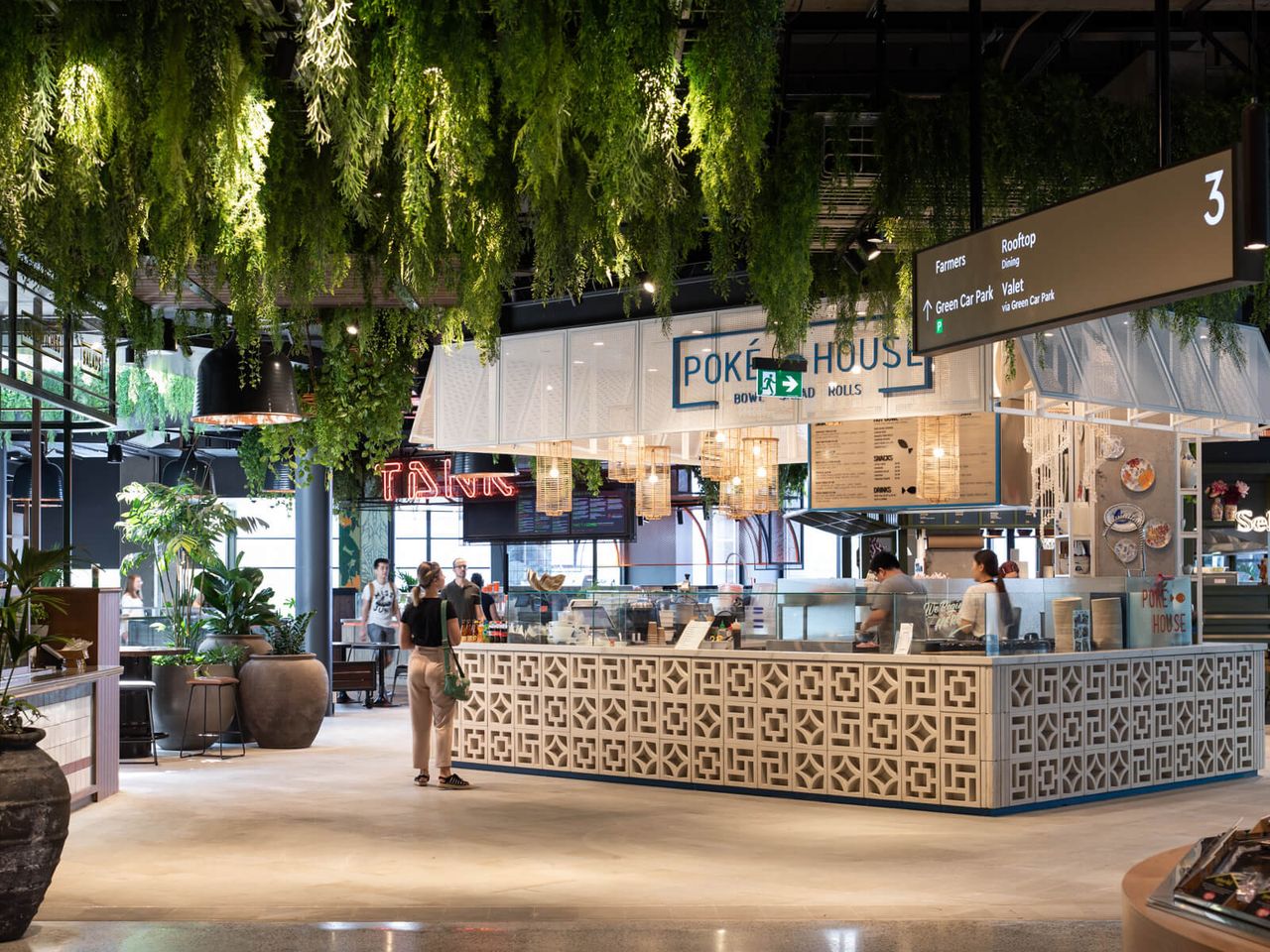 Poke House restaurant at Westfield Mall, featuring intricate patterned counters, hanging greenery, and a modern open-plan layout. A vibrant and welcoming hospitality space in Auckland.